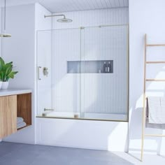 a bathroom with a sink, mirror and shower stall in the corner next to a ladder