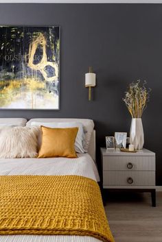 a bedroom with gray walls and yellow accents