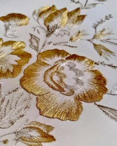 gold and silver flowers on white fabric