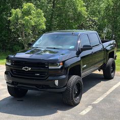 a black pickup truck parked in a parking lot