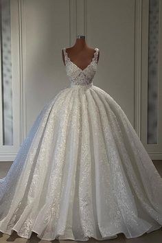 a white wedding dress on display in front of a wall with mirrors and closets behind it