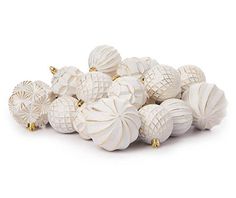 a pile of white ornaments sitting next to each other on top of a white surface