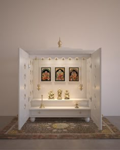 a white room with three buddha statues on the wall