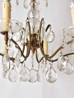 an antique chandelier with crystal drops hanging from it