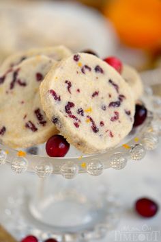 two cranberry shortbread cookies sitting on top of a glass plate