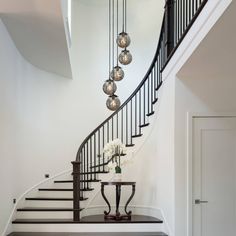 an elegant staircase with glass balls hanging from it