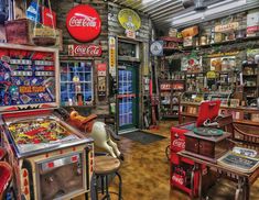 a room filled with lots of old fashioned machines and tables covered in coca cola memorabilia