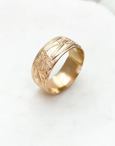 One of our most-loved rings ~ Marigold is a cigar band ring with a vintage floral design. Add this charming piece to your collection to stack or make a statement. * Recommended to order 1/2 size up from your normal ring size. This band tends to fit tight. ﻿Band width: 8 mm // Band thickness: 0.5 mm Modeled with our bold rope ring Handmade to order in high-quality 14k gold fill to withstand daily wear time after time. Heirloom Ring With Thick Decorative Band, Heirloom Rings With Decorative Wide Band, Heirloom Ring With Decorative Wide Band, Heirloom Engraved Ring With Decorative Wide Band, Yellow Gold Rings With Decorative Thick Band, Heirloom Rings With Decorative Round Band, Fine Jewelry Engraved Ring With Decorative Band, Fine Jewelry Engraved Wide Band Wedding Ring, Heirloom 14k Gold Wide Band Wedding Ring