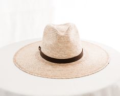 Hats are sized at 58cm (large) and include an adjustable inner, cotton sweatband for a more comfortable fit. Each hat comes with a genuine brown leather hatband.

Each handmade hat is unique and may have small imperfections or vary in size and color. All Leah products are responsibly sourced and ethically crafted. Rustic Brown Brimmed Straw Hat, Brown Country Style Panama Hat With Short Brim, Brown Short Brim Sun Hat For Ranch, Adjustable Brown Flat Brim Sun Hat, Classic Brown Adjustable Sun Hat, Adjustable Brown Sun Hat With Short Brim, Classic Adjustable Brown Sun Hat, Brown Brimmed Panama Hat For Ranch, Brimmed Brown Panama Hat For Ranch