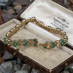 This lovely bracelet is accented with forty-eight (48), prong set, marquise mixed cut natural emeralds and thirty-two (32), channel set, round brilliant cut diamonds. The bracelet measures 7.2mm wide, 4.0mm thick and an overall length of 7 inches. The bracelet is finished with a hidden box clasp. Yellow Gold Emerald Jewelry With Marquise Cut, Luxury Yellow Gold Marquise Bracelets, Heirloom Marquise Emerald Jewelry, Green Emerald Bracelet, Luxury Yellow Gold Emerald Bracelet, Classic Emerald-cut Emerald Bracelet, Emerald Bracelet, Box Clasp, Channel Set