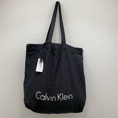 Black Calvin Klein Tote Bag, Light Weight Chic Black Canvas Bag With Dust Bag, Black Canvas Pouch Bag For Shopping, Calvin Klein Rectangular Bag For Everyday, Trendy Calvin Klein Rectangular Bag, Black Canvas Bag With Removable Pouch For Shopping, Chic Black Canvas Bag With Adjustable Strap, Modern Black Cotton Shoulder Bag, Calvin Klein Black Shoulder Bag With Removable Pouch, Modern Calvin Klein Shopping Bag