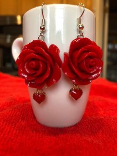 24mm polyresin red rose beads with dangling little 8mm red heart charms. 2 inches in length. If you want to spice up that outfit with a bright pair of red earrings these are for you. The perfect Holiday, Valentines Day, Mothers Day, or Birthday gift.❤️🌹 Cheap Rose-colored Jewelry For Valentine's Day, Cheap Rose Jewelry For Valentine's Day, Cheap Valentine's Day Jewelry With Flower Charm, Cheap Rhinestone Jewelry For Valentine's Day, Cheap Party Jewelry With Rose Design, Cheap Rose Design Jewelry For Party, Cheap Bohemian Valentine's Day Earrings, Cheap Statement Jewelry For Valentine's Day, Unique Cheap Red Earrings