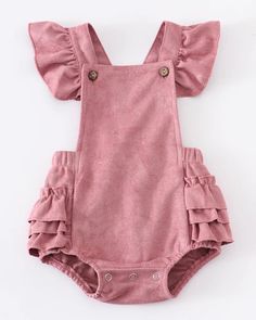 Suede is in this spring and this ruffled romper is stunningly precious.  Layer this beautiful style with a long-sleeved top or romper and tights.  This style coordinates with our Suede Ruffled Jonjon.  Snap button closure for easy changes.   Machine Washable.  Hang or Lay Flat to Dry.  Color: Rose  Sizes:  3M, 6M, 12M and 18M. Spring Cute Bubble Romper With Ruffle Sleeves, Spring Cotton Bubble Romper With Ruffle Sleeves, Cute Bubble Romper With Ruffle Hem For Spring, Cute Spring Bubble Romper With Ruffle Hem, Spring Cotton Bubble Romper With Ruffled Straps, Chic Cotton Jumpsuits And Rompers With Ruffles, Chic Cotton Jumpsuit With Ruffles, Spring Bubble Romper With Ruffles, Cotton Bubble Romper With Ruffle Sleeves