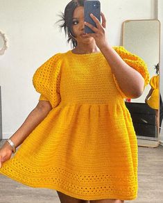 a woman is taking a selfie in the mirror wearing a yellow dress and holding a cell phone