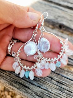 The earrings are made of beautiful natural moonstones dangle  on silver hooks and natural  pearl in the middle of the hook. The blue crystal of apatite between dangling moonstones add the sofisticated look. Complex in color - moonstones and pearls have iridescent colors. Perfect pear of earrings for your wedding gown.  The size of the pearl is 12 mm in diameter.  Length ( with ear hooks) is a little over 2 1/2 inches. The ear wires are silver plated. Please visit my Policies page for shipping and additional information: http://www.etsy.com/shop/BridalBay/policy Arrives in a gift box for easy gift-giving. Bohemian Sterling Silver Jewelry With Pearl Drop, Bohemian Sterling Silver Pearl Drop Jewelry, Silver Teardrop Chandelier Earrings With Natural Stones, Natural Stone Dangle Pearl Earrings, Bohemian Silver Chandelier Earrings With Pearl Drop, Silver Bohemian Chandelier Earrings With Pearl Drop, Handmade Briolette Pearl Earrings, White Pearl Earrings With Natural Stones For Wedding, White Natural Stone Pearl Earrings For Wedding