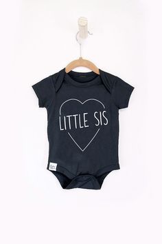 Little sis onesie for baby girl. Grab a matching set for your crew with the rest of our Big + Little tee's. Cute Pre-shrunk Onesie, Cute Unisex Pre-shrunk Onesie, Spring Cotton Onesie For Family Matching, Family Matching Spring Cotton Onesie, Spring Family Matching Cotton Onesie, Casual Onesie With Letter Print For Loungewear, Casual Unisex Onesie With Letter Print, Spring Cotton Bodysuit With Relaxed Fit, Cute Cotton Onesie For Loungewear