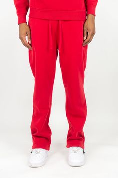 Our Solid Sweatpants are designed with both comfort and functionality in mind. Made with a solid color that never goes out of style, these sweatpants are perfect for any activity. Enjoy a comfortable fit and look great while staying active. Regular fit 100% Polyester Fleece Adjustable drawstring Red Cotton Joggers With Relaxed Fit, Red Cotton Relaxed Fit Joggers, Red Relaxed Fit Cotton Joggers, Red Relaxed Fit Joggers For Loungewear, Red Casual Sweatpants For Loungewear, Casual Tracksuit With Side Pockets For Sports, Red Cotton Joggers With Elastic Waistband, Casual Sports Sweatpants With Drawstring, Red Relaxed Fit Sweatpants For Loungewear