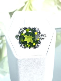 Natural or Simulated Green Peridot Ring  Speechless Design#103 MADE TO ORDER Inspired by Victorian era filigree designs, I now offer this stunning Antique inspired ring in sterling silver. This fabulous ring is set with a 6ct stunning green peridot gemstone (Simulated or Natural gemstone options). The round full cut high-quality AAA gemstone is 12mm (just shy of 1/2th of an inch) in diameter, and has very good color and clarity. The inside of the band is marked 925 for sterling silver. Notice th Classic Peridot Jewelry With Accent Stones, Classic Peridot Rings With Prong Setting, Classic Peridot Jewelry, Classic Peridot Jewelry With Prong Setting, Classic Peridot Solitaire Jewelry, Classic Solitaire Peridot Jewelry, Classic Round Cut Peridot Jewelry, Classic Peridot Jewelry For Formal Occasions, Classic Peridot Green Rings