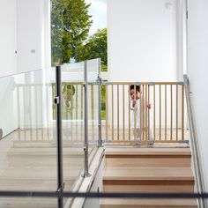 a person standing on some stairs talking on a cell phone and looking at something in the distance