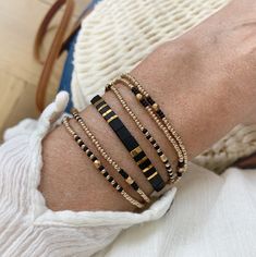 Beautiful set of two bracelets, a beaded strech wrap bracelet, wraps 5 times around your wrist, with champagne gold and black Japanese seed beads and a lovely adjustable Tila beaded bracelet with black and gold square flat beads on silk cord. This set is Lightweight and very comfortable to wear, the perfect summer stack! M A T E R I A L * Wrapbracelet: Seed beads from Miyuki (high quality seed beads from Japan) champagne gold, black and facet beads, very strong elastic * Tila bracelet: Silk cord Elegant Adjustable Wrap Bracelet With Tiny Beads, Elegant Gold Friendship Bracelets With Colorful Beads, Elegant Heishi Bead Bracelets With Tiny Beads, Black Bracelets With Tiny Beads For Party, Elegant Multi-strand Tiny Beaded Bracelets, Adjustable Multi-strand Beaded Bracelet With Gold Beads, Gold Friendship Bracelets With Colorful Beads For Parties, Adjustable Multi-strand Gold Beaded Bracelets, Elegant Adjustable Wrap Bracelet With Colorful Beads