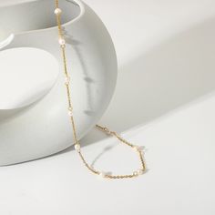 The Pearl Station Necklace features evenly spaced pearls on an 18k gold-plated chain, offering timeless elegance. Its classic yet modern design is versatile, ideal for both everyday sophistication and formal occasions. Tiny Pearl Necklace, Gold Pearl Necklace, Freshwater Pearl Necklace, Station Necklace, Pearl Pendant Necklace, Pearl Charms, Freshwater Pearl Necklaces, Gold Chain Necklace, Metal Necklaces