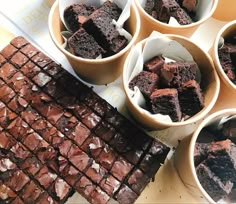 chocolate brownies and other desserts in bowls on a table