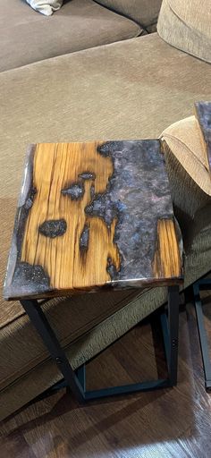 a wooden table sitting on top of a hard wood floor next to a chair and couch