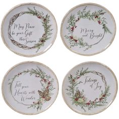 four white plates with holly wreaths and sayings on the front, one for each plate