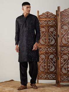 Vastramay Men's Black Mirror Georgette Kurta With Patiala Set Make a statement in this elegant black kurta with a stylish mirror work design. The georgette fabric adds a touch of luxury, perfect for festive occasions or special events. Features: Black georgette kurta with mirror work Patiala set for a complete traditional look Comfortable and stylish Specifications: Brand: VASTRAMAY Color: Black Fabric: Georgette Neck: Mandarin Collar Sleeve Length: Full Sleeves Material & Care: Georgette, Dry-c Mirror Work Design, Intricate Mirror, Georgette Kurta, Stylish Mirror, Black Kurta, Kurta Pyjama, Comfortable Pajamas, Work Design, Kurta With Pants