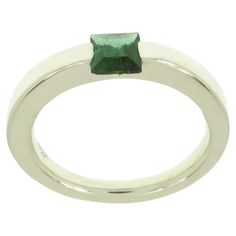 Very stylish modern band ring crafted in 9k white gold featuring at the centre a square cut natural green tourmaline. The dimension of the gemstone is 5 x 5 millimeters / 0.196 x 0.196 inches. This ring is also available with square cut gold topaz in 9 karat rose gold (1stDibs Ref: LU126214706422) and together they can be worn as stacking rings. Us finger size 6.5 / Italian size 13 / French size 53. Adjustable to the customer's size before shipping. Handmade in Italy by Botta Gioielli and marked Modern Emerald Ring With Polished Finish For Promise, Modern Emerald Promise Ring With Polished Finish, Modern Emerald Cut Stackable Promise Rings, Modern Square Cut Promise Ring, Green Diamond Stackable Ring For Formal Events, Modern Stackable Gemstone Rings For Formal Events, Modern Gemstone Stackable Rings For Formal Events, Modern Gemstone Stackable Rings For Formal Occasions, Modern Green Diamond Ring For Formal Occasions