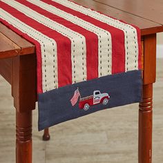 a red, white and blue table runner with a truck on it