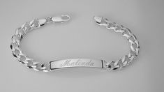 "This solid sterling silver bracelet is 8\" long and features a flat, diamond cut curb chain with a lobster claw clasp. The engravable identification plate is about 1.5\" long and a bit over .25\" wide and about 1/8\" thick. This is a heavy bracelet, weighing about 32 g. It has a high polish, shiny finish These look fabulous with a name, initials, a date or even Roman numerals. Delivered to you in a gift box. To see my current selection of bracelets: https://www.etsy.com/shop/AnniesHours?section Classic Adjustable Curb Chain Jewelry, Classic Adjustable Silver Name Bracelet, Hallmarked White Gold Chain Bracelet For Anniversary, Anniversary Hallmarked Link Chain Bracelet, Anniversary White Gold Hallmarked Chain Bracelet, Classic Silver Name Bracelet, White Gold Sterling Silver Name Bracelet With Engraving, Classic White Gold Name Bracelet, Classic Name Bracelet With Curb Chain As A Gift