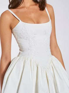 Introducing the alluring Kadi White Cotton Corset Mini Dress, a delightful addition to your wardrobe. Crafted from crisp low stretch Cotton Poplin, this mini dress exudes casual elegance. Delicate lace detailing adorns the garment, adding a touch of charm. The V-shaped waistline and the built-in bones accentuates your figure, while the lace-up back and adjustable stripes ensures a perfect fit. With invisible pockets and mesh bustle inside seamlessly integrated into the design, this dress offers Drop Waist Short Wedding Dress, Wedding Dress Cotton, V Shaped Waistline Dress, Corset White Dress, Wedding Corset Dress, Mini Bridal Dress, White Grad Dress, Embroidered White Dress, White Corset Dress