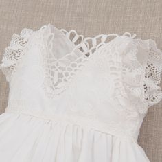 **Shipping by 3/15** Handmade in the USA A delicately detailed cotton lace with a scalloped edge layered to create a simply elegant look for her special day! Lightly ruffled lace sleeves are a perfect touch to the lace bodice. Pair with her matching Lily accessories to complete her look. 100% light ivory cotton lace Light ivory edge lace Ivory silk ribbon Lace Bonnet, Christening Dress, Ivory Silk, Christening Gowns, Eyelet Lace, Lace Bodice, Create Outfits, Ivory Lace, Romper Dress