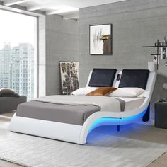 a modern bed with an illuminated headboard and foot board is shown in this bedroom