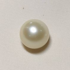 a white pearl is sitting on the surface