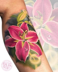 a woman's arm with pink flowers on it