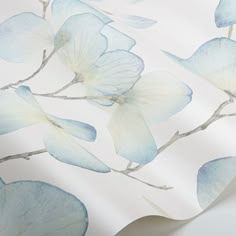 a wallpaper with blue flowers and leaves on the back of it's surface