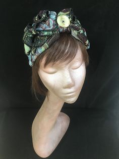 1940s floral print turban style head band. A real statement piece with a standard width inner Alice band attached within the lining to provide an easy to wear design. Completed with quills of fabric, buttons and lined with a fine fleece. The perfect accessory for style and added warmth. This unique creation is a stunning example of a vintage inspired accessory with an eye catching easy to wear and lightweight design. Adjustable Bohemian Headwrap Headband, Bohemian Adjustable Headwrap With Matching Headband, Adjustable Bohemian Headwrap With Matching Headband, Traditional Headscarf As Headband, Bohemian Festival Headwrap Scarf, Bohemian Headwrap One Size Fits Most, Bohemian One Size Fits Most Headwrap, Bohemian Fitted Headscarf Headband, One Size Turban With Scarf Headband