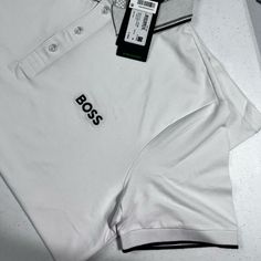 A Versatile Polo Shirt By Boss Menswear. Offered In A Straight Fit For A Casual Silhouette, This Short-Sleeved Polo Shirt Is Designed In Cotton-Blend Piqu With Active-Stretch Qualities For Optimum Comfort. Boss Branding Appears On The Front And Back, While The Collar And Cuffs Are Detailed With 3d Stripes. Size Xl Logos Color, Boss Brand, Boss Shirts, Slim Fit Polo, Blue Polo Shirts, Cotton Polo Shirt, Cotton Polo, Logo Color, Slim Fit Men