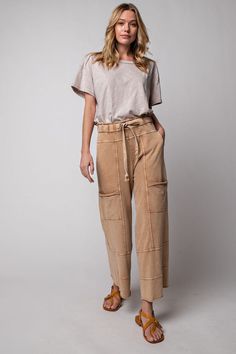 These must-have Terry Knit Wide Leg Pants are crafted from 100% cotton for maximum comfort and breathability. Featuring cargo style pockets, an elastic waistband and drawstring, and exposed seaming, they provide all-day comfort and style. Perfect for any occasion! Utility Parachute Pants For Loungewear, Relaxed Bottoms With Drawstring For Fall, Relaxed Drawstring Bottoms For Fall, Relaxed Fit Bottoms With Drawstring For Fall, Casual Beige Bottoms With Patch Pockets, Beige Cotton Bottoms With Pockets, Utility Pants With Hip Pockets For Loungewear, Casual Tapered Leg Sweatpants With Patch Pockets, Casual Sweatpants With Patch Pockets And Tapered Leg