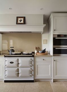 a stove top oven sitting inside of a kitchen