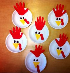 paper plates with chicken faces on them are arranged in the shape of handprints