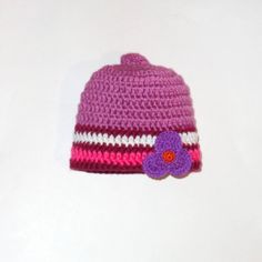 a crocheted hat with a flower on it