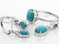 9x7mm oval, 8x6mm oval, and 6x4mm oval sleeping beauty turquoise with .16ctw round white topaz rhodium over sterling silver ring, pendant with 18" Singapore chain and earring set.  Ring measures approximately 3/8"L x 1/16"W.  Earrings measures approximately 1"L x 3/16"W and have a leverback closure.  Pendant measures approximately 3/4"L x 5/16"W.  3mm bail and lobster claw clasp closure with 2" extnder.  Not sizeable.  Rhodium plated Turquoise Fine Jewelry With Polished Finish, Turquoise Sterling Silver Jewelry With Accent Stones, Sterling Silver Jewelry With Oval Cabochon Accent Stones, Turquoise Oval Jewelry With Diamond Accents, Oval Turquoise Jewelry With Diamond Accents, Sterling Silver Jewelry With Oval Cabochon Gemstone Accents, Sterling Silver Jewelry With Gemstone Accents Oval Cabochon, Fine Jewelry Turquoise Oval Cabochon, Fine Jewelry Oval Turquoise Jewelry