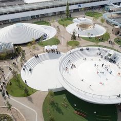 an aerial view of people walking around in the park