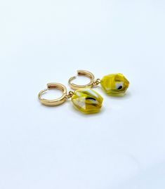 18K gold plated brass hoop huggie earring with yellow Handmade Artisan Glass Faceted Nugget Beads that are 13x16mm. Earring is 15mm wide with a lever back closure - you simply pull to open the clasp and push together to close.  Note: Do not push down on the lever clasp or it may bend & will be unable to close. Check out this same style in emerald green! https://www.etsy.com/listing/1126692726/emerald-green-glass-bead-hoop-huggie?click_key=e32a9fa50f772d226e127d772ec7a1ec2dabcc7e%3A1126692726&click_sum=0bb96875&ref=shop_home_active_2 Handmade Gold Teardrop Huggie Earrings, Handmade Gold Huggie Earrings, Handmade Gold Huggie Dangle Earrings, Yellow Drop Hoop Earrings As Gift, Handmade Yellow Gold Plated Earrings, Handmade Gold Dangle Huggie Earrings, Gold Dangle Huggie Earrings With Lever Back, Hypoallergenic Yellow Hoop Earrings As Gift, Gold Teardrop Huggie Earrings With Ear Wire