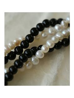 Experience the timeless contrast between black onyx and white pearls with this simple yet striking design. Natural pearls add a soft beauty, while black agate adds a unique charm. This necklace can be DIY by yourself. The two beads are scattered and have a sense of hierarchy. They are twisted together and have a sense of design Metal: 18ct Recycled Gold Plated On Brass Gemstone: Black Onyx Pearl: Freshwater Pearl (4-4.5mm) Length: 360-410mm Weight: 18g Necklaces Pearl, Natural Pearl Necklace, Soft Beauty, Double Layer Necklace, Edison Pearls, Gemstone Beaded Necklace, Layer Necklace, Pearl Necklaces, Tiger Eye Stone