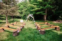 an outdoor wedding setup with wooden benches