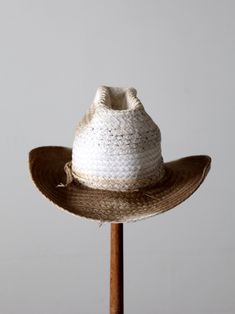 "This is a vintage white straw cowboy hat. The classic woven hat shows fantastic wear with a darkening to the tone of the brim. Rockmount Kushion-Komfort interior hat band. CONDITION In good condition with wear consistent with age and use. General wear and aged tone. Tiny spot of end fray on the side brim. MARKED SIZE: 7 MEASUREMENTS Interior Circumference: 21.75\" .. 55.2 cm Height: 5.25\" .. 13.3 cm Brim: 3.25\" .. 8.3 cm 72037" White Country Style Hat With Flat Brim, Classic White Straw Hat For Ranch, Western White Hat With Curved Brim, White Western Hat With Short Brim, White Panama Hat With Short Brim For Rodeo, White Western Style Panama Hat, White Short Brim Hat For Ranch, White Short Brim Panama Hat For Rodeo, White Brimmed Hat Bands For Rodeo